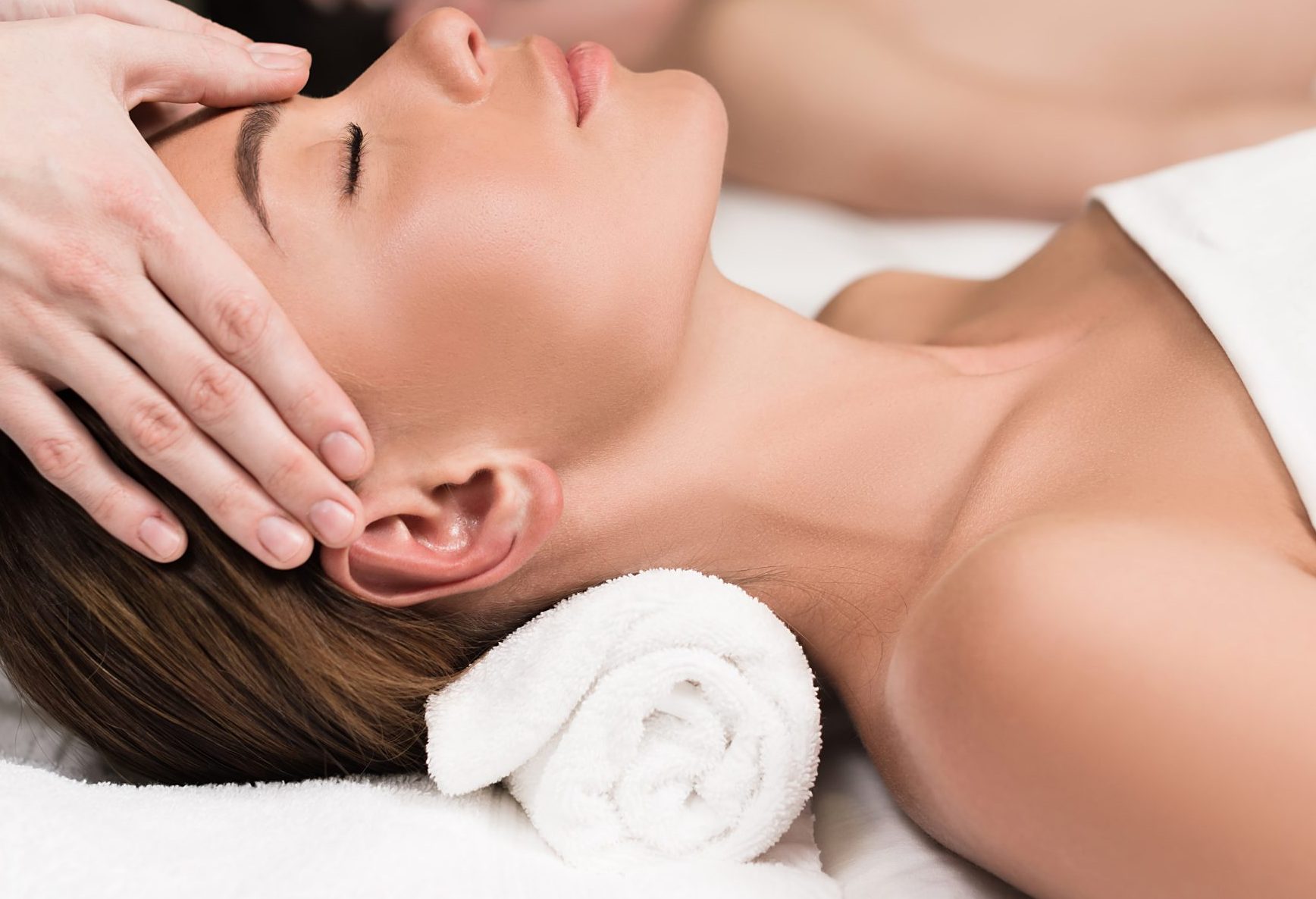 close-up partial view of young couple having massage in spa salon